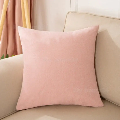 A soft blush pink velvet pillow cover with textured fabric finish from a pastel pillow cover set for living room decor