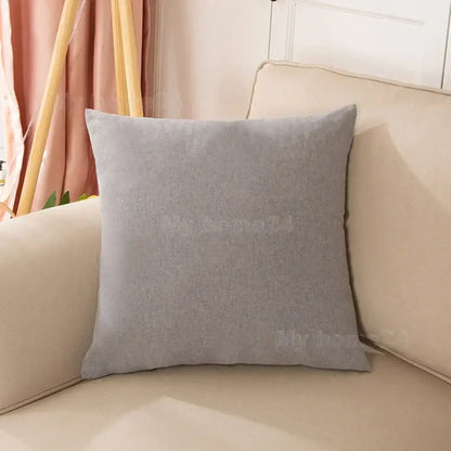 A soft gray velvet pillow cover set with textured fabric on a beige couch for living room decor