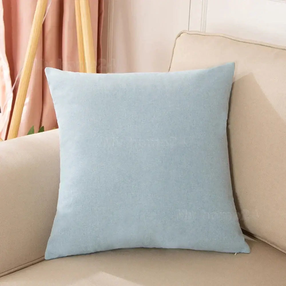 A soft light blue pastel velvet pillow cover set with subtle texture on a beige sofa for living room decor