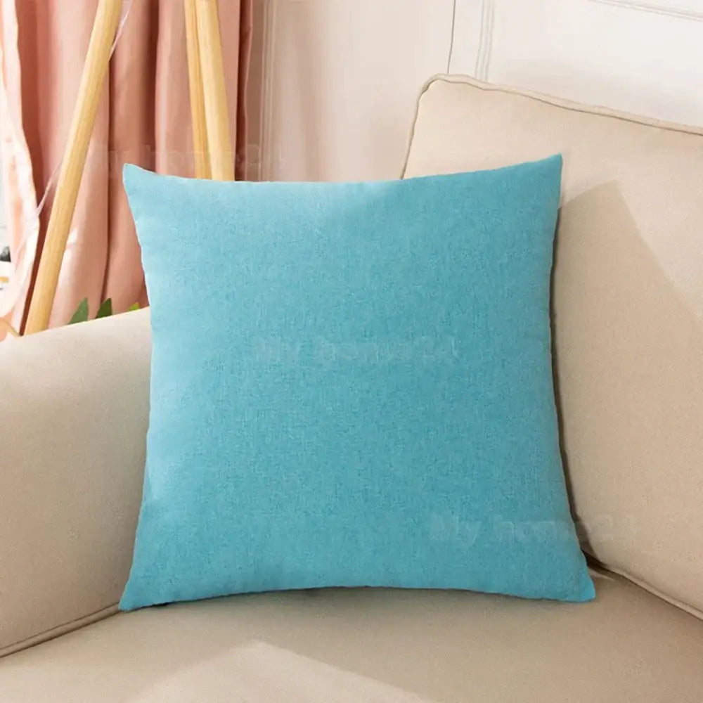 A soft pastel velvet turquoise pillow cover set with textured fabric on a beige sofa for living room decor