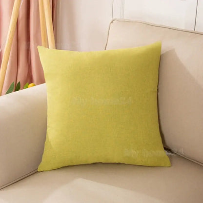 A lime green pastel velvet pillow cover with textured fabric on a beige sofa from a pillow cover set