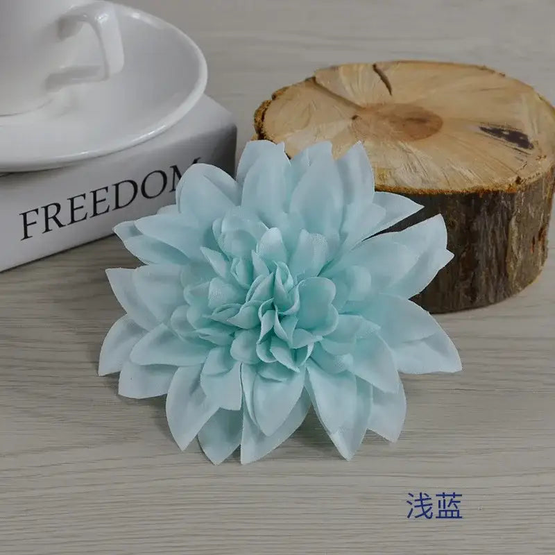 A delicate light blue woolen chrysanthemum wreath bouquet with layered ruffled petals for wedding decoration
