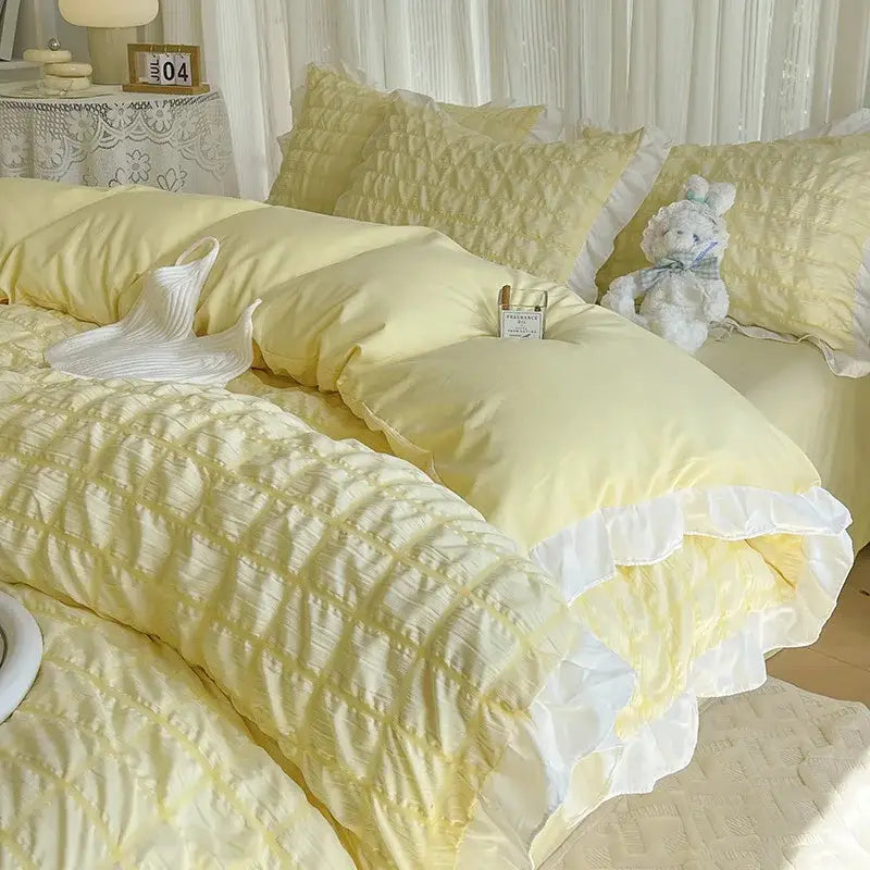 Soft pastel yellow quilted bedding set with delicate white ruffled trim featuring decorbites bubble cotton lace design