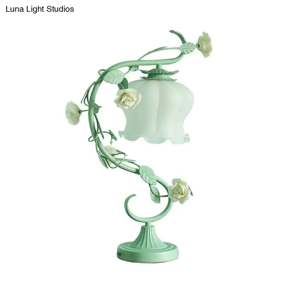 A delicate mint-green metal pastel turquoise table lamp with white roses and usb charger for bedroom use