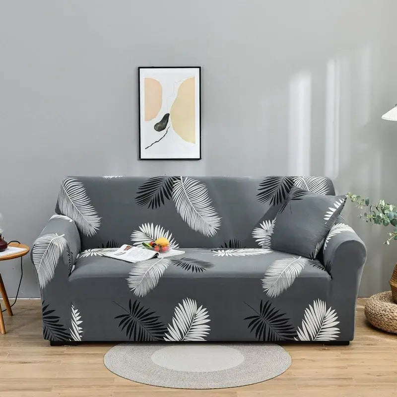 Gray sofa covered in a black and white palm leaf stretch fabric slipcover for living room use