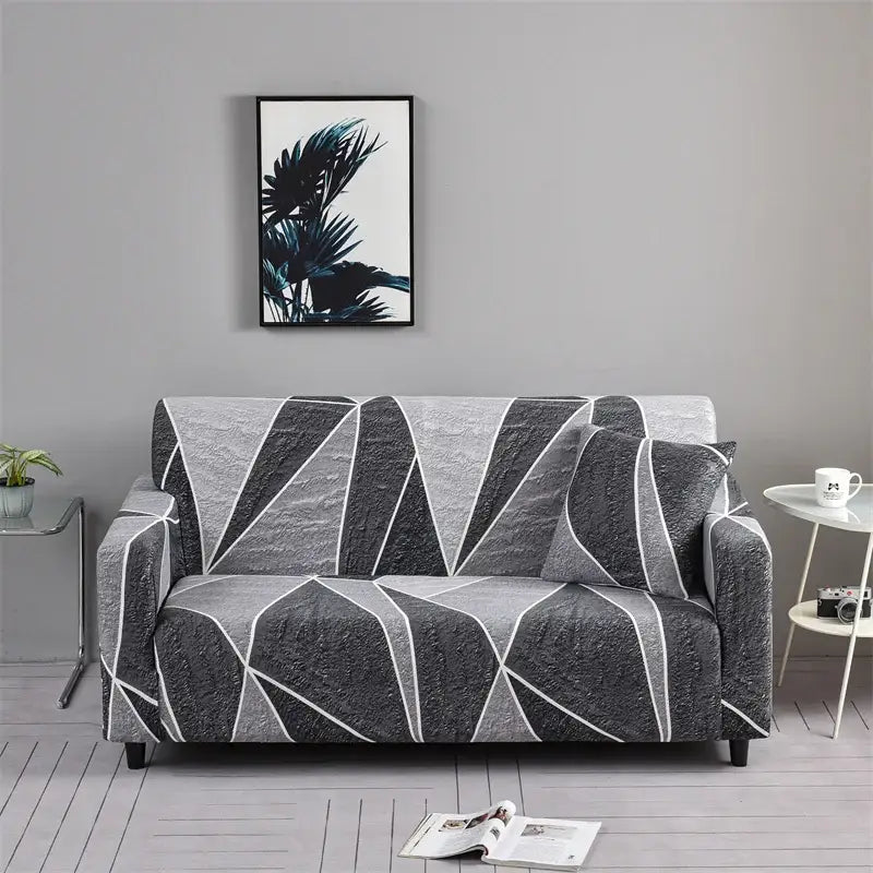 A sleek gray and white geometric patchwork mandala printed stretch sofa cover with textured fabric for living room use