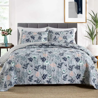 Gray quilted bedspread with navy pink and green floral pattern in patchwork rust and cream coverlet bedding set