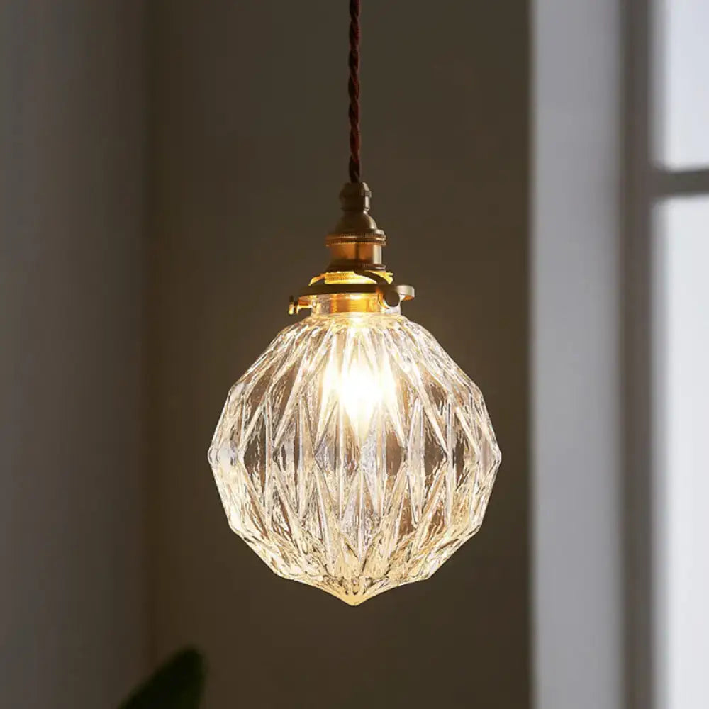 Clear faceted glass ceiling light with brass fixture and twisted cord in pauline modern industrial sphere design for living room