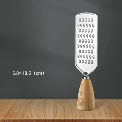 A sleek stainless steel multifunctional grater with a wooden handle and engraved paw print for versatile kitchen use