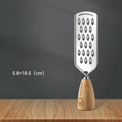 A sleek stainless steel 3-in-1 multifunctional grater with a wooden handle and engraved paw print hua jia tian text