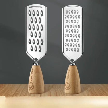 Two stainless steel graters with wooden paw print handles feature distinct hole patterns in a 3-in-1 multifunctional grater design