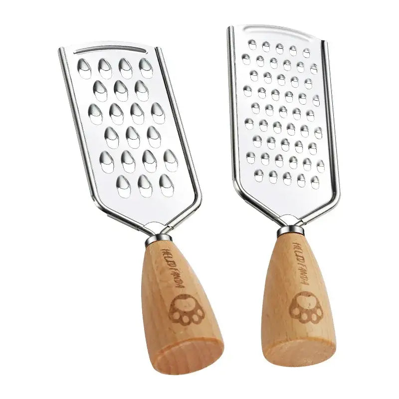 A pair of stainless steel paw print engraved hederwood multifunctional graters with wooden handles for kitchen use