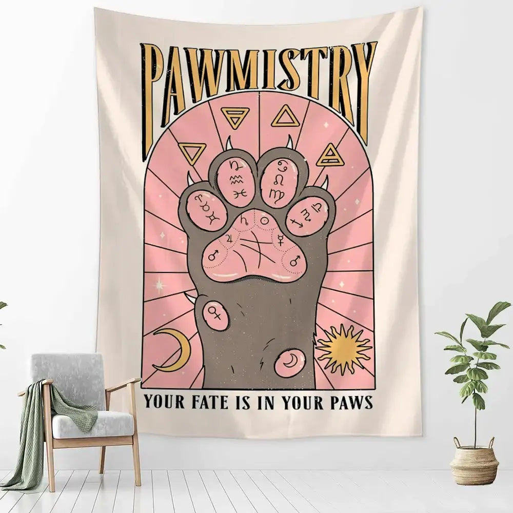 A beige wall tapestry featuring a stylized cartoon cat claw paw print with astrological symbols for bedroom decor