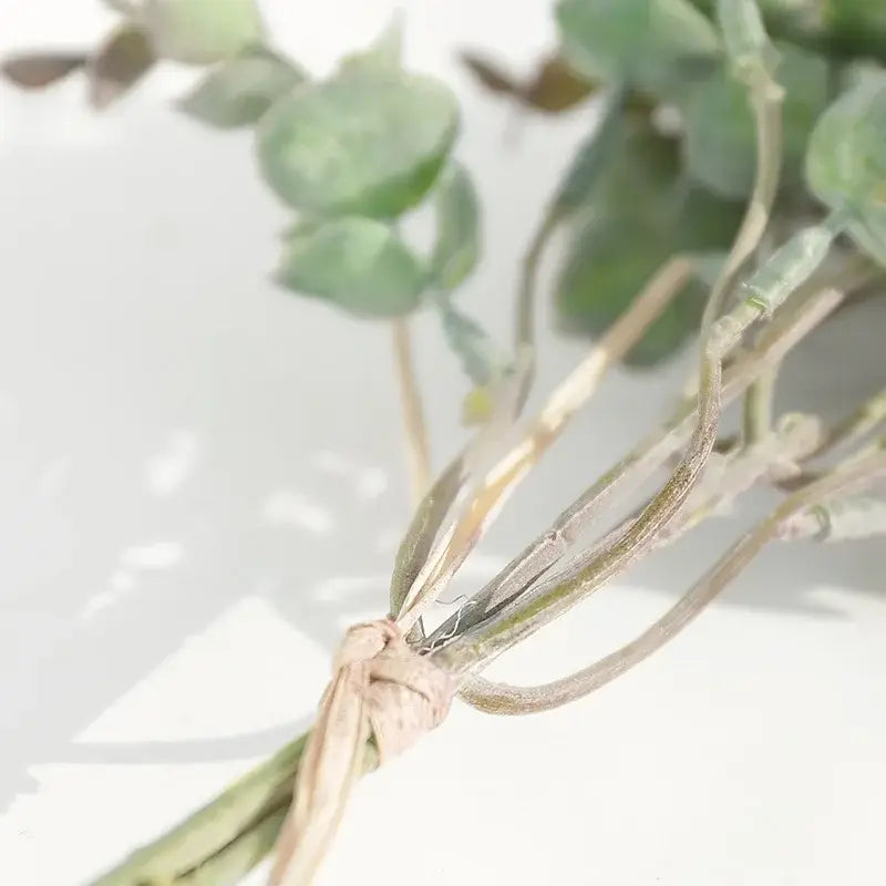 A bundle of pale green eucalyptus leaves artificial tied with rustic twine for peach and green decorbites eucalyptus leaves arrangement