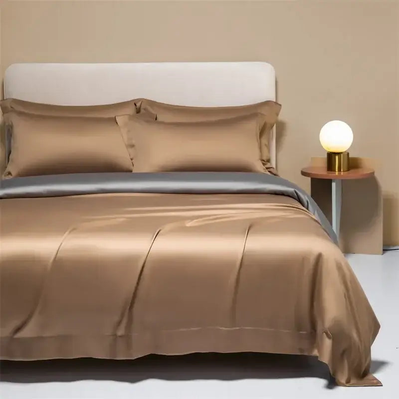 The bed features a luxurious gold satin peach satin cooling cotton solid bedding set with matching pillows for bedroom use