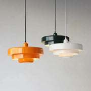 Three-tiered pendant lighting in vibrant orange black and white featuring bauhaus style retro pendant lamp design