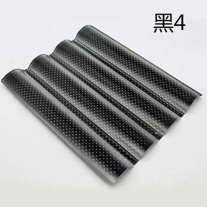 Black glossy plastic wave bread pan with perforated design and evenly spaced white dots for non-stick baking