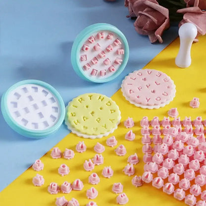 Pastel-colored pink and yellow plastic decorbites cookie stamps set with circular letter and word designs for baking