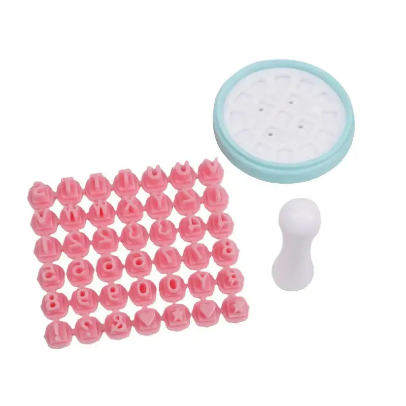 Pink and blue decorbites cookie stamps set with pink plastic letters and symbols and a light blue circular base plate