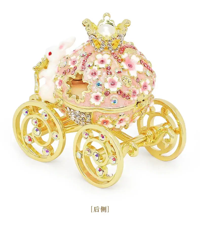 Pink and gold princess carriage jewelry trinket box with floral enamel, crystal embellishments, and pearl crown decor