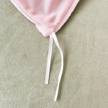A soft pink milk velvet bedding set with textured weave and white drawstrings for winter bedroom comforter