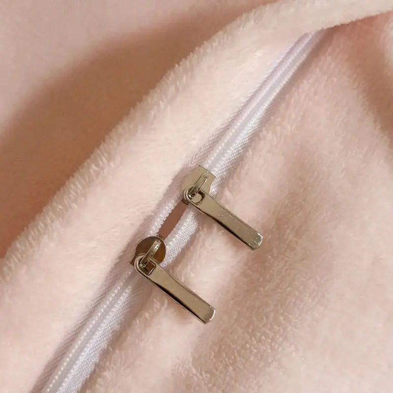 Silver-toned zipper pulls on soft blush-pink fleece fabric of pink and silver french lace ruffles bedding set decorbites