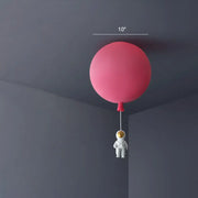 Pink astronaut ceiling lamp featuring a balloon-shaped acrylic pendant light with a small astronaut figurine for kids bedroom