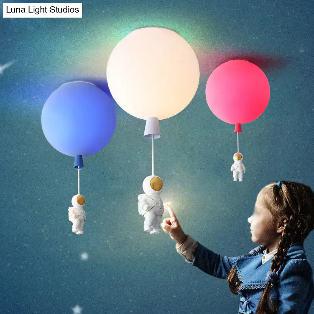 Pink astronaut ceiling lamp featuring colorful balloon-shaped acrylic pendant light with astronaut figurines for kids bedroom