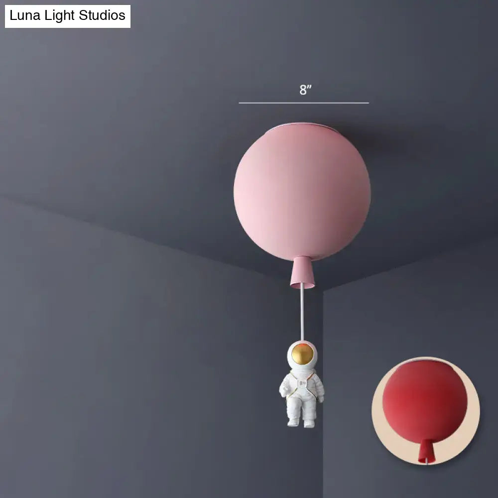 Pink astronaut ceiling lamp with acrylic pendant light shaped like a balloon and white astronaut figurine for kids bedroom