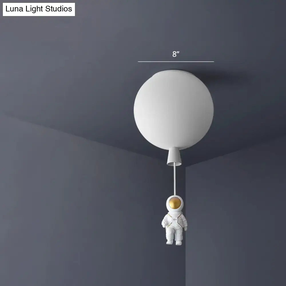 White balloon-shaped acrylic pendant ceiling lamp with miniature pink astronaut figure for kids bedroom lighting