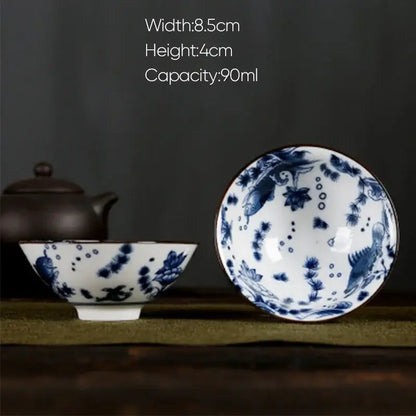 A delicate white porcelain hand-painted tea bowl with blue underglaze floral and fish motifs from decorbites blue collection