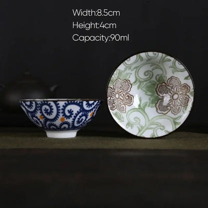 White porcelain hand-painted tea bowl with blue and orange swirls exterior and green floral interior decorbites blue