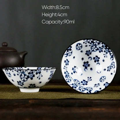 A delicate white porcelain hand-painted bowl with intricate blue floral decorbites blue patterns and matching rim