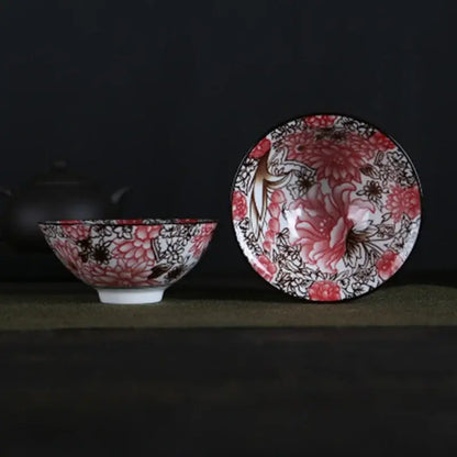 A pair of white porcelain hand-painted bowls with intricate pink and black floral patterns and glossy finish