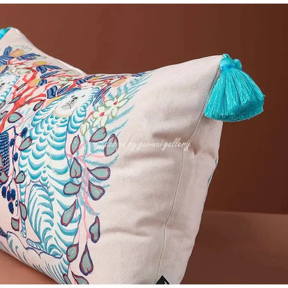 Cream-colored pink and blue lion dog lumbar pillow cover with vibrant stylized animals and turquoise tassel for bedroom decor