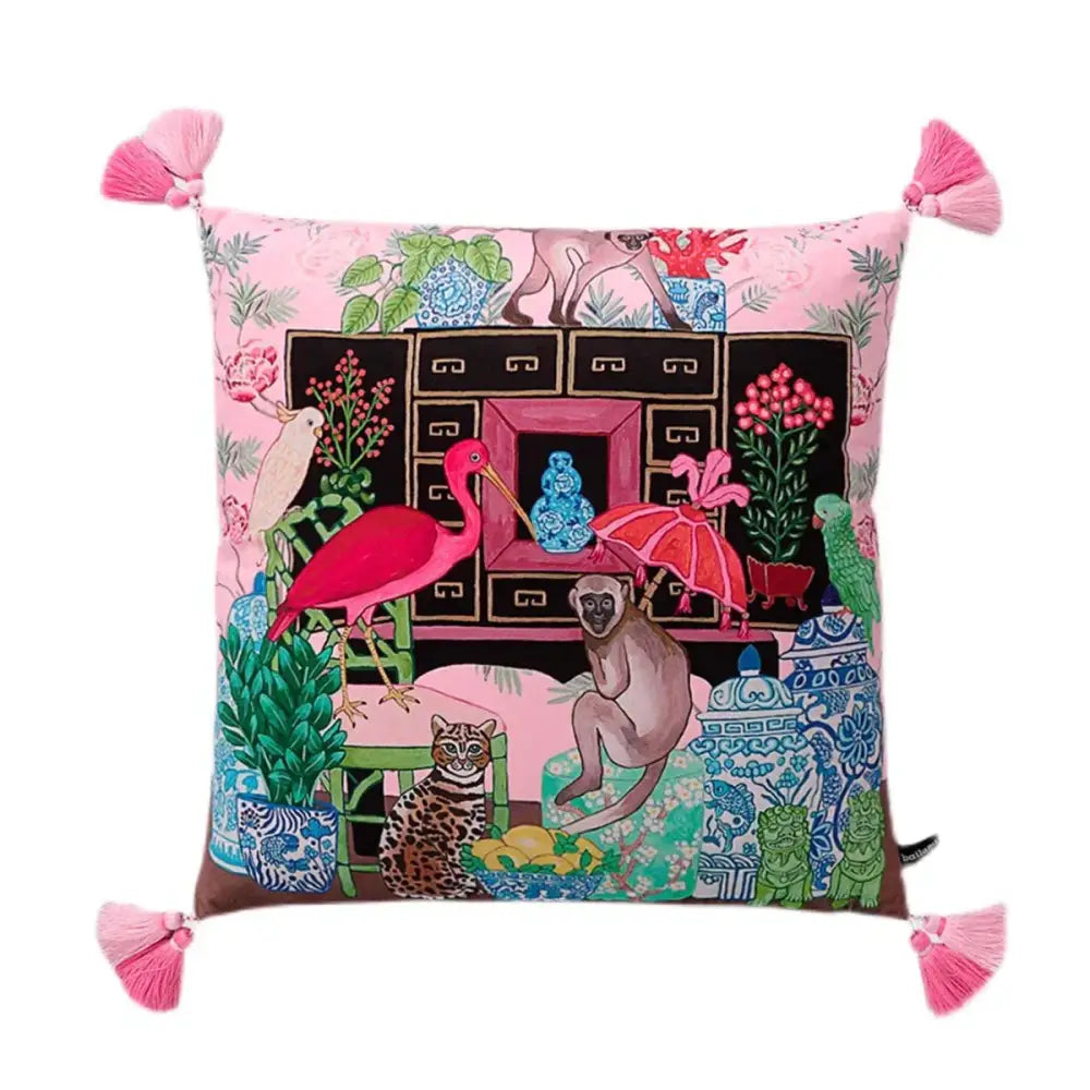 Pink cushion cover with vibrant embroidered blue lion dog and whimsical animals plants design for bedroom decor