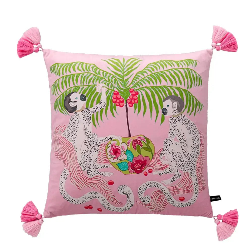Pink cushion with vibrant spotted monkeys under palm tree and pink tassels in blue lion dog lumbar pillow cover design