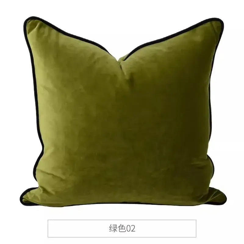 Olive green velvet pillow with black trim complementing a pink and blue lion dog lumbar pillow cover for bedroom decor