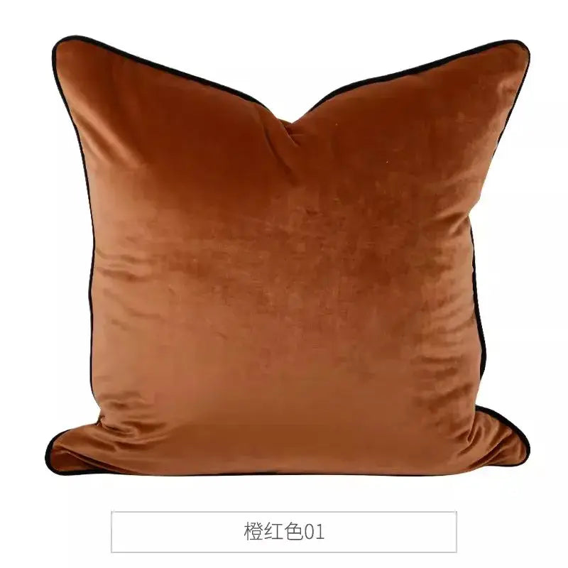 A plush burnt orange velvet square cushion with black piping for bedroom tiger decor featuring a blue lion dog theme