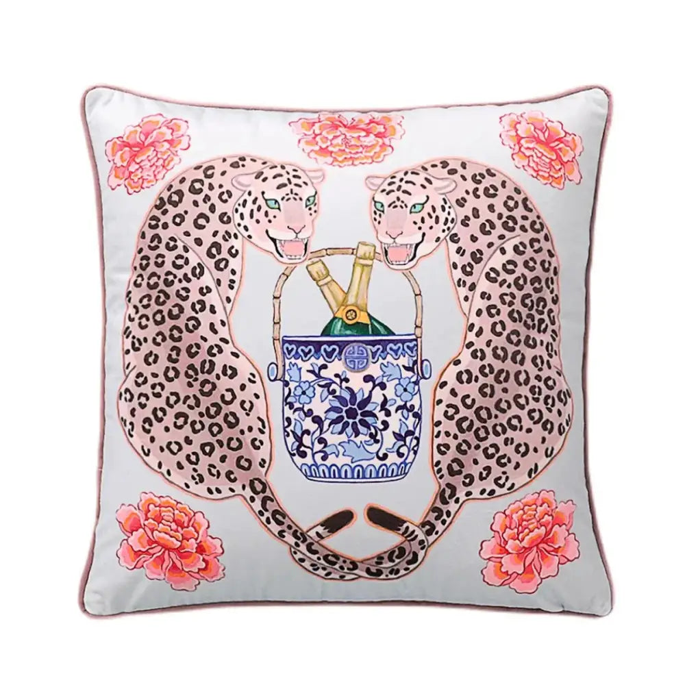 A square light gray fabric lumbar pillow cover featuring two pink leopard lion dogs holding a blue lion porcelain ice bucket