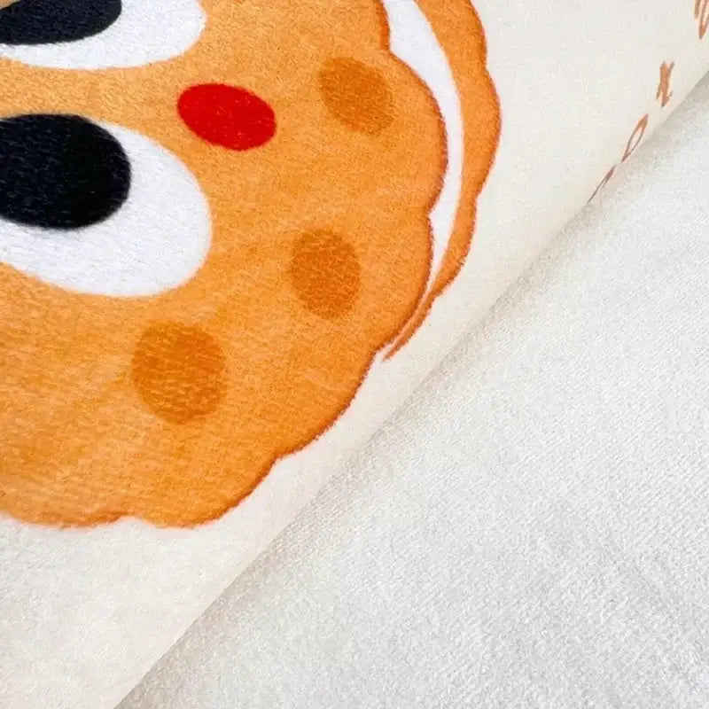Orange plush cookie with black and red eyes on soft white fabric on pink cartoon print plush bathroom mat decorbites cartoon print