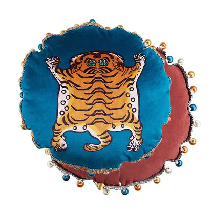 Plush circular deep teal velvet cushion with stylized orange tiger and pom-poms complements decorbites cat print velvet decor