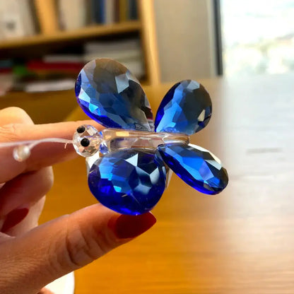 A sparkling blue crystal butterfly figurine with faceted wings and clear glass body for bedroom decorbites decor