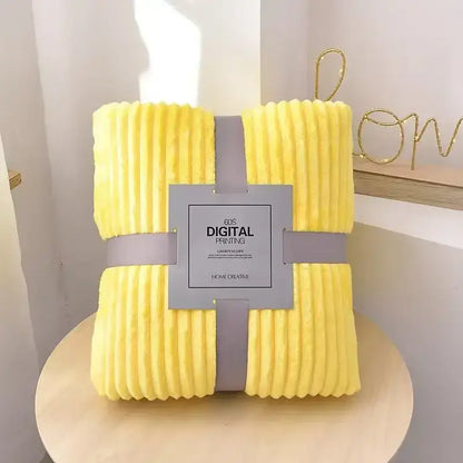 Bright yellow corduroy throw blanket with soft ribbed texture wrapped in gray ribbon complements decorbites cozy striped flannel fleece