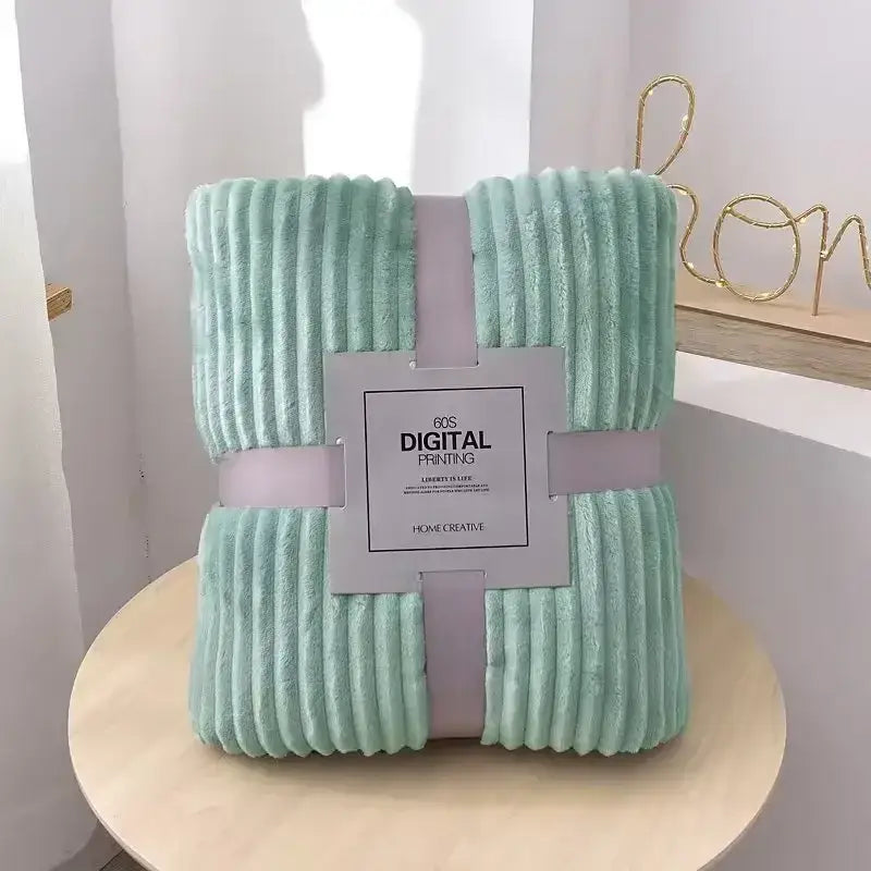A soft mint green corduroy throw blanket wrapped with a light purple ribbon for decorbites cozy striped flannel fleece use