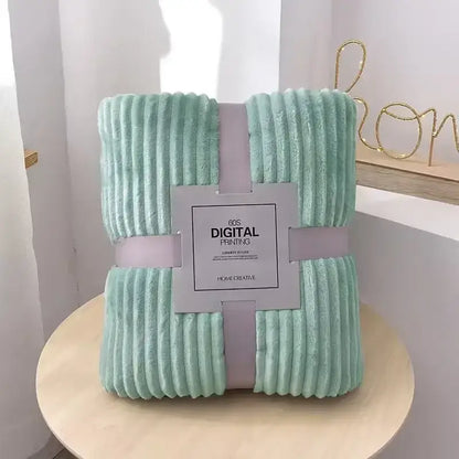 A soft mint green corduroy throw blanket wrapped with a light purple ribbon for decorbites cozy striped flannel fleece use