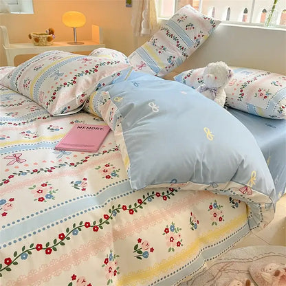 Pink and cream bed set featuring pastel floral decorbites cotton cartoon printed fabric with delicate ribbon accents
