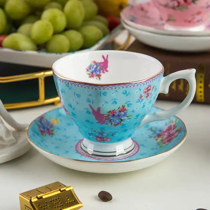 A delicate turquoise bone china flower tea cup set with pink floral and bunny motifs and gold trim for Phnom Penh afternoon