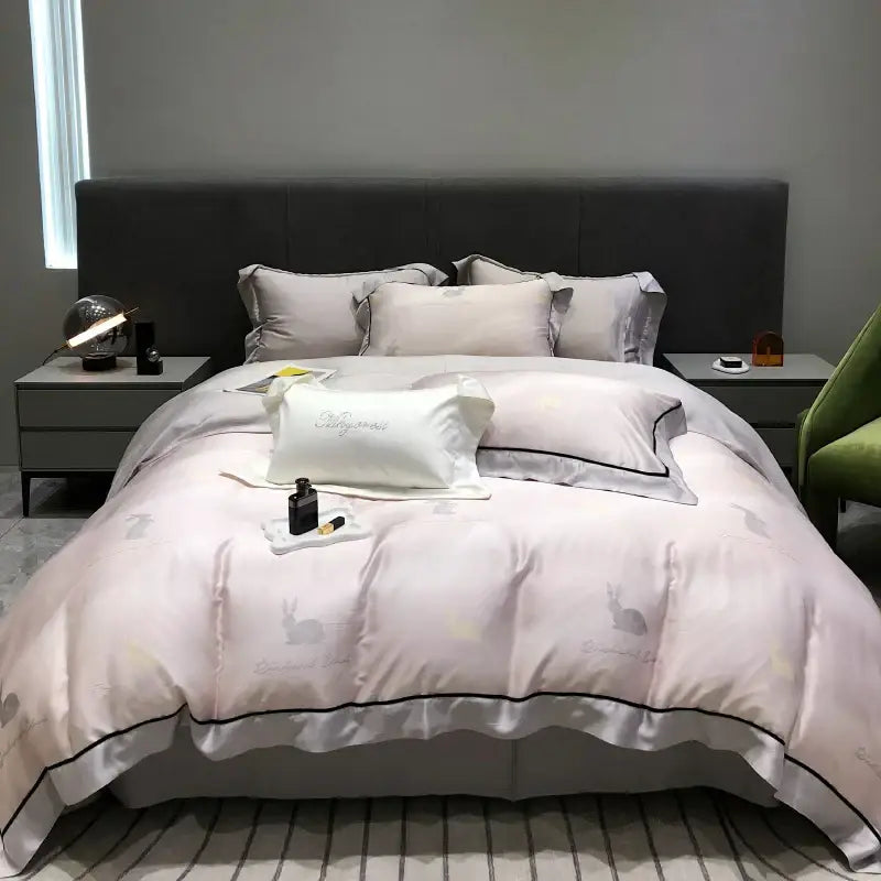 Soft blush pink satin duvet set with subtle rabbit embroidery and black piping in decorbites eucalyptus lyocell flowers