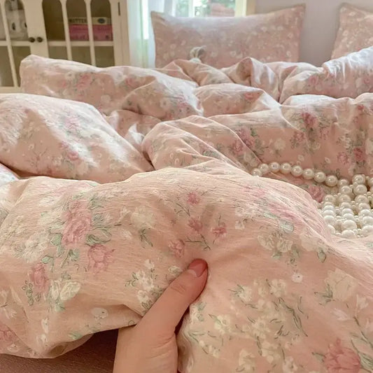 Soft pink floral jacquard fitted sheet set with delicate pastel blossoms and textured yarn for bedroom use